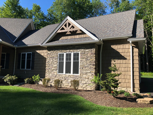 Stone and shingle siding on a modern craftsman home