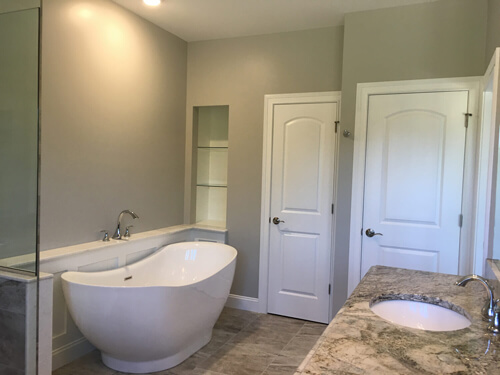 Master bathroom bathtub and closets